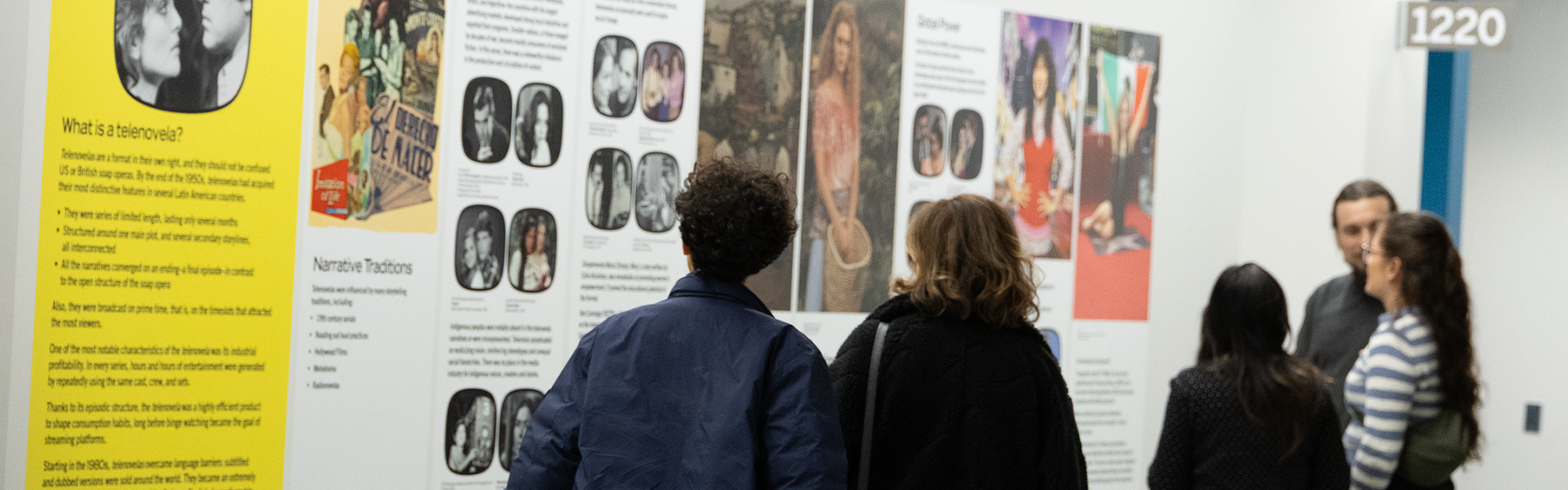 People viewing Telenovela exhibits on the walls in the FIMS & Nursing Building